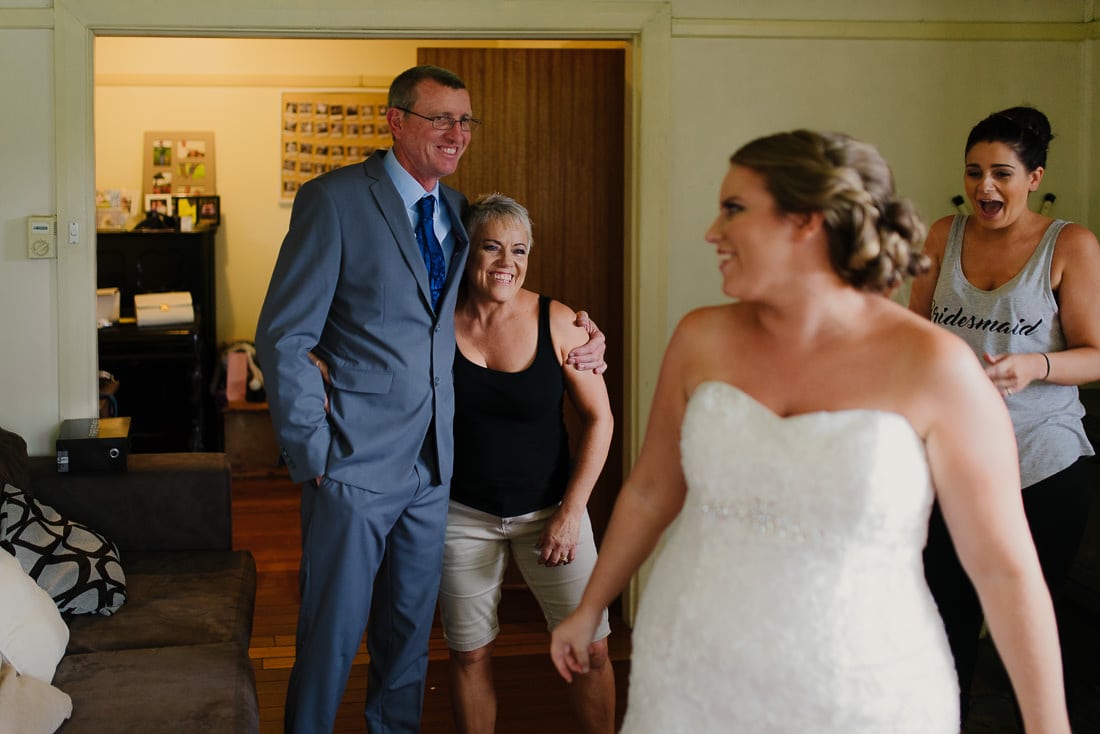 Proud parents look towards their daughter as a bride